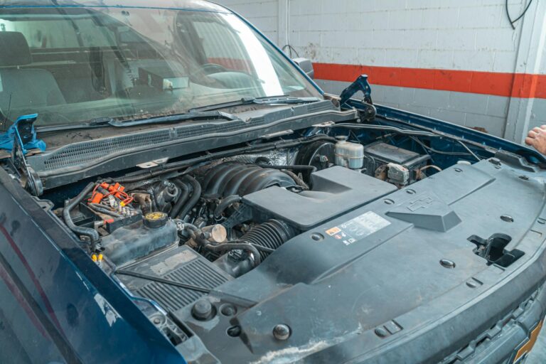Close-up image of a car engine being repaired in a garage workshop. Ideal for automotive themes.